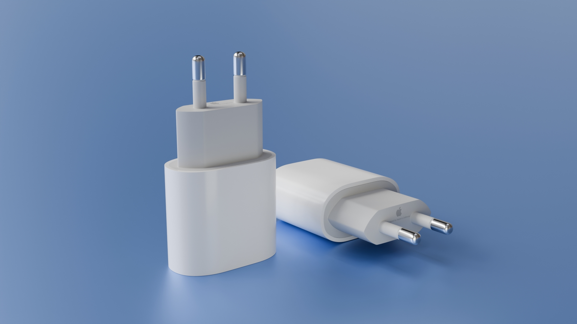 Deux chargeurs secteur en 3D, l’un debout et l’autre couché, montrant les broches métalliques et le design arrondi sur un fond bleu.